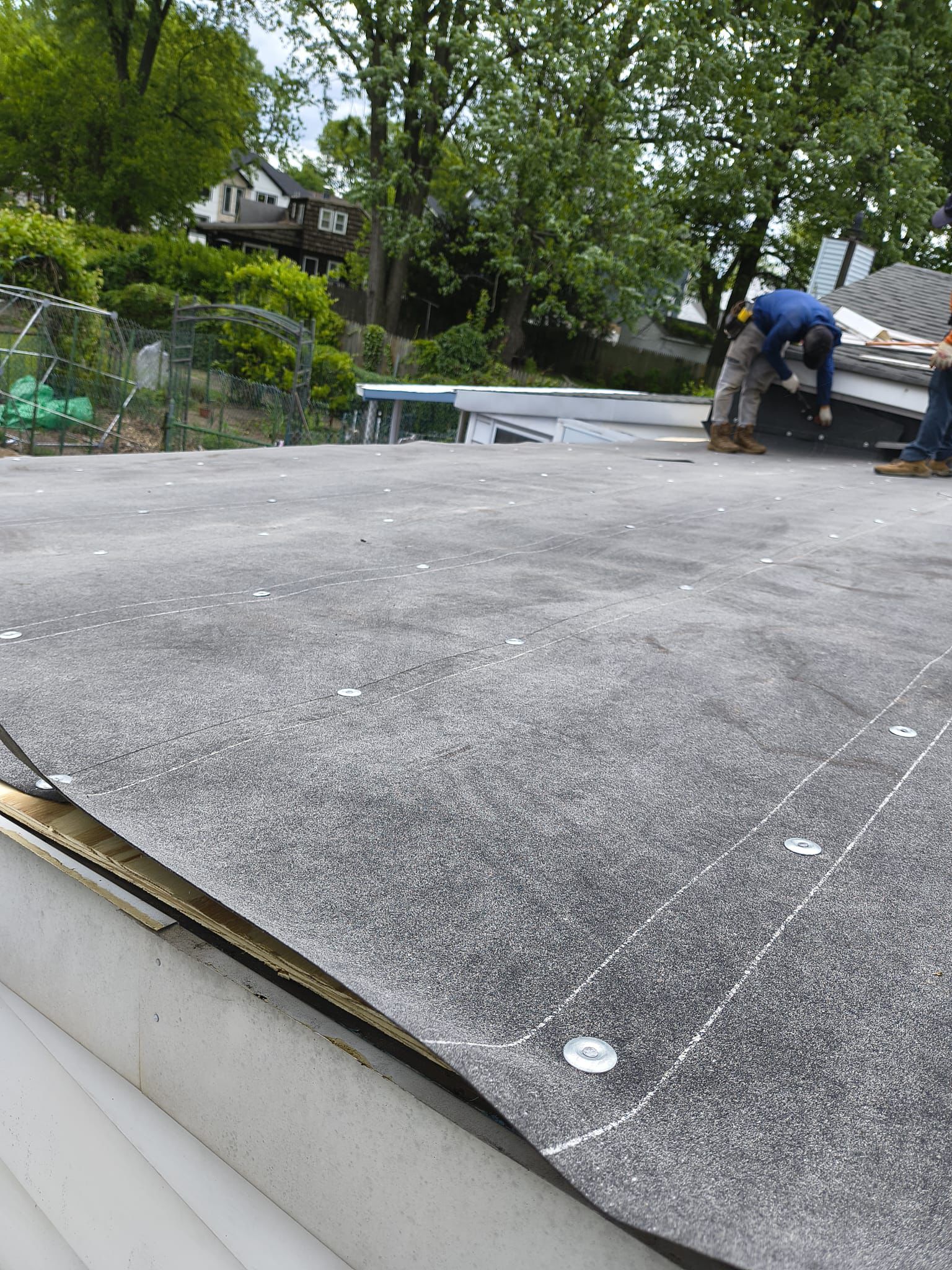 EPDM membrane being rolled out across the prepped deck